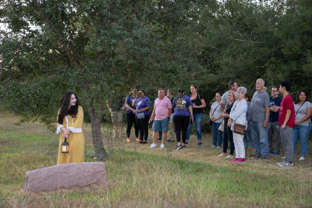 Actor from the Pearl Theater mid-scene at the Old Settlers Cemetery in Pearland during Hops and History event