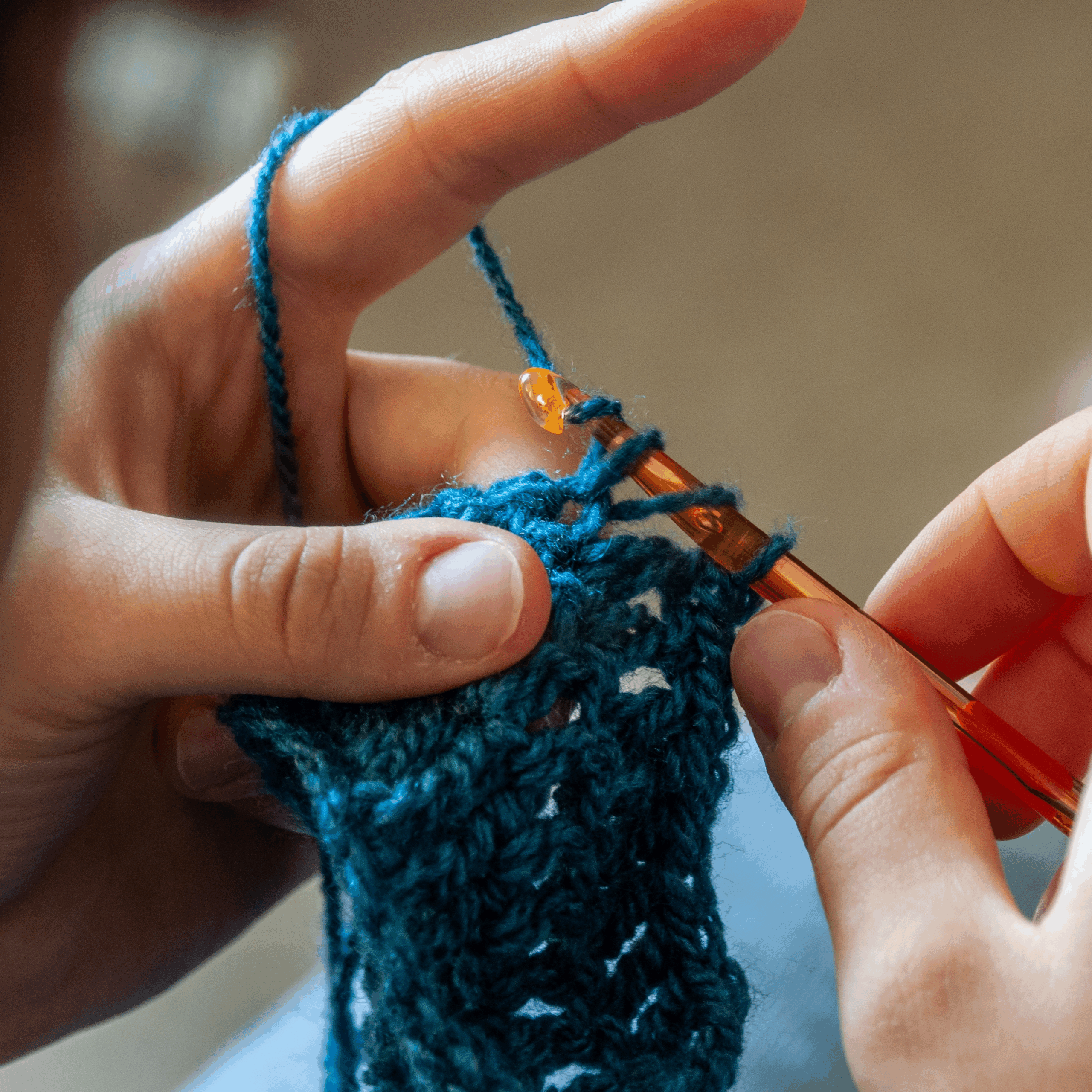 Hands Knitting a Blue Blanket Stock Photo
