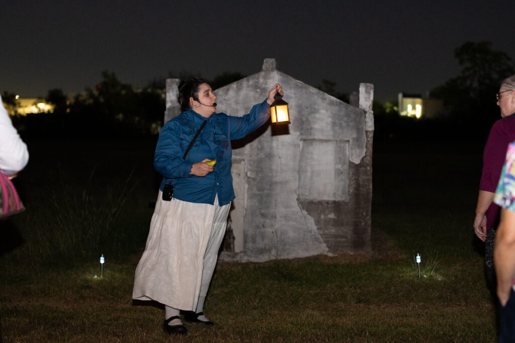 Hops and History actor wields lamp at the Old Settlers Cemetery
